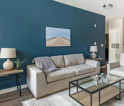 A living room with a couch, chair, and coffee table.