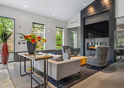 A modern living room with a grey sofa and a wooden coffee table.