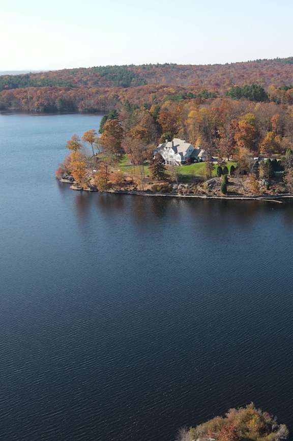 an aerial view of a lake with a house on the shore at Woodbury, Woodbury, CT, 06798