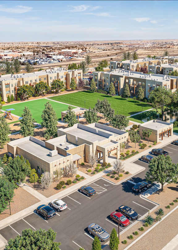 Aerial view of apartment buildings with parking and landscaping at Turquoise Trail Apartments, Santa Fe