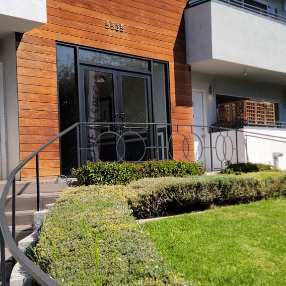 A modern building with a wooden facade and a glass door.