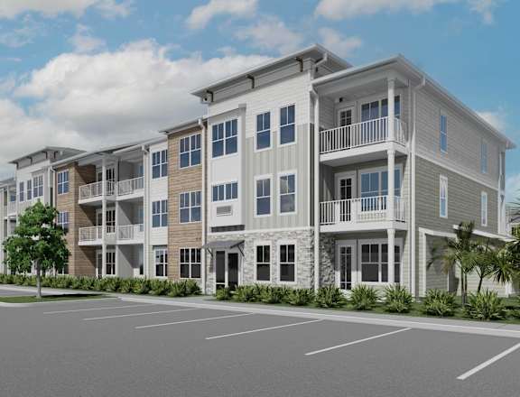 A row of modern apartment buildings with a parking lot in front at Verity Luxury Apartment Homes Apartments, Vero Beach, Florida