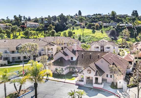 A cluster of houses with a red flag in front of one house. at Whispering Fountains Diamond Bar, Diamond Bar