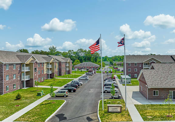 A street view of a residential area with a flag flying in the background.