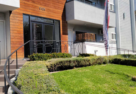 A modern building with a wooden facade and a glass door.