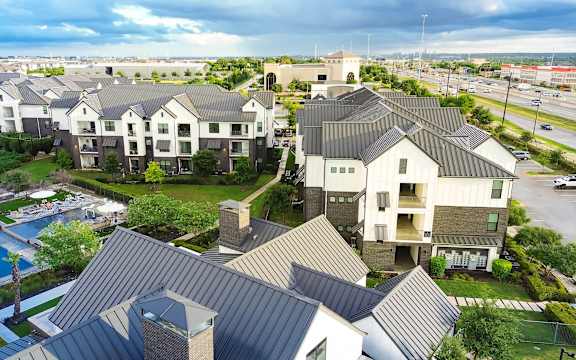 A large, modern residential complex with a swimming pool.