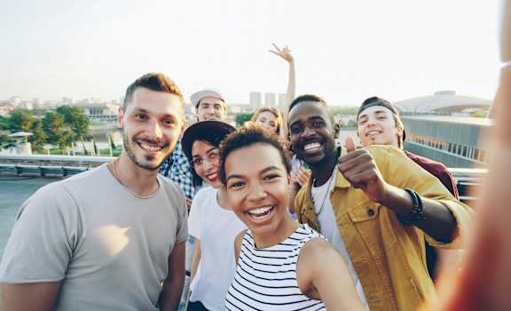A group of people are standing together and smiling for a photo.