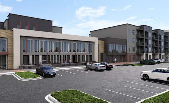 A parking lot with cars and a building in the background.