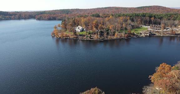 an aerial view of a lake with a house on the shore at Woodbury, Woodbury, CT, 06798