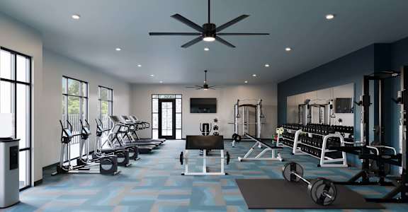 A spacious gym with a variety of equipment and a blue patterned floor.