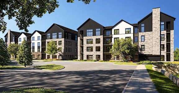 A large, modern building with a mix of black and beige exterior walls.