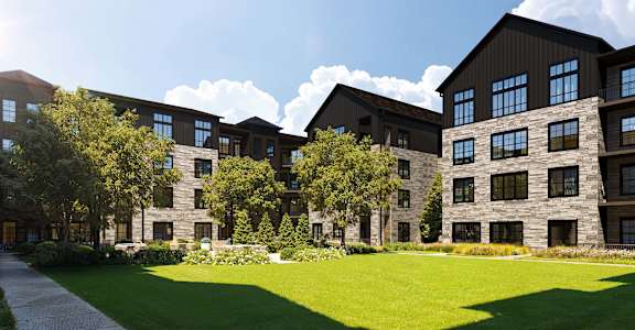 A large building with a green lawn in front.