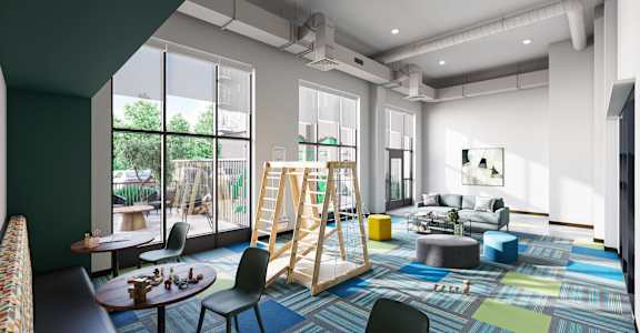A modern, multi-purpose room with a play area, seating, and a dining table.