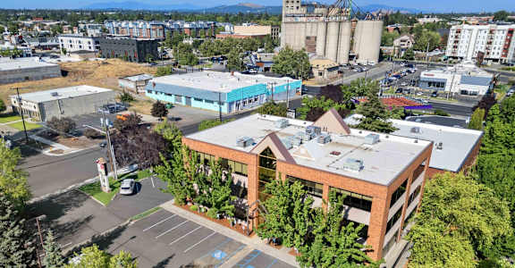 A large building with a parking lot in front of it.