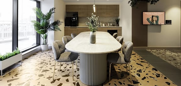 a dining room with a marble table and chairs
