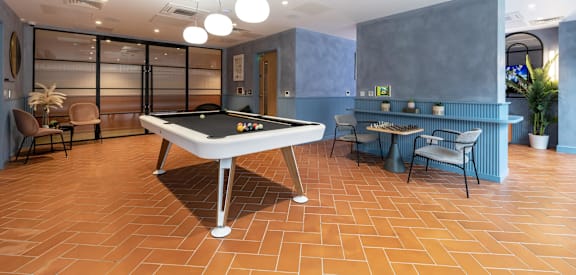 a game room with a pool table and a bar