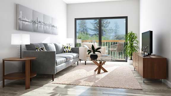 A modern living room with a grey sofa, a wooden coffee table, a TV, and a large window with a view of the outdoors.