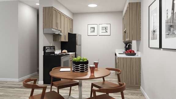 A kitchen with a table and chairs.