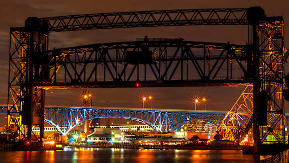 A bridge over a body of water with lights on it.