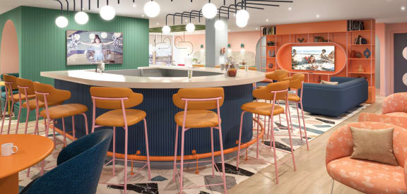 a restaurant with a round bar and orange and blue stools