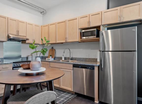 a kitchen with stainless steel appliances and a small table