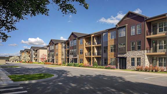 A row of modern apartment buildings with a clear blue sky above.