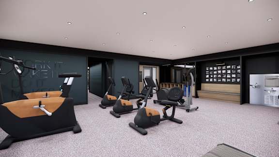 A gym with a variety of equipment including a rowing machine, a bench press, and a squat rack.