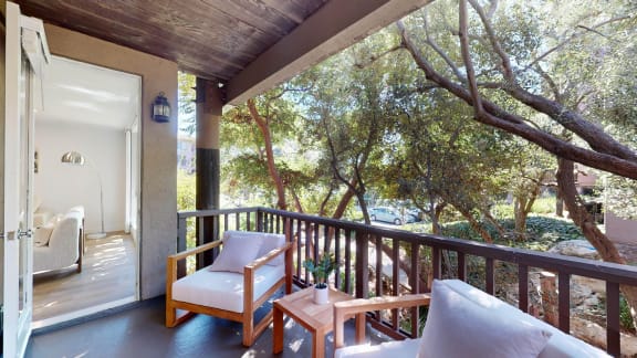 a porch with chairs and a table on a balcony  at Mariners Village, Marina del Rey, 90292