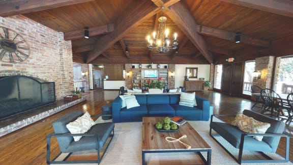 the living room has a large brick fireplace and couches at The Meadows Apartments, Culver City , CA 90230