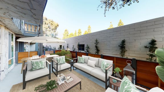 a patio with white furniture and a table and chairs at The Meadows Apartments, Culver City , CA 90230