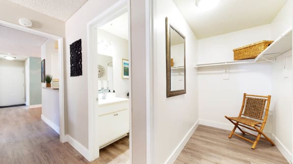 a bathroom with a mirror and a wooden chair at Mountain Vista, Victorville, California