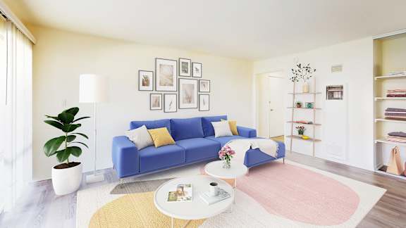 a living room with a blue couch and a pink rug at West Park Village, Los Angeles, California