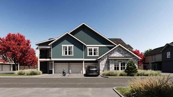 A green house with a black car parked in front. at The Woods at Copper Ranch, Hailey, 83333