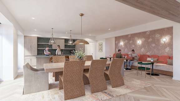 A modern dining room with a long table and chairs.