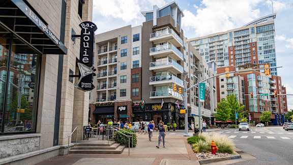 A street view of a city with a bar named Bar Louie.