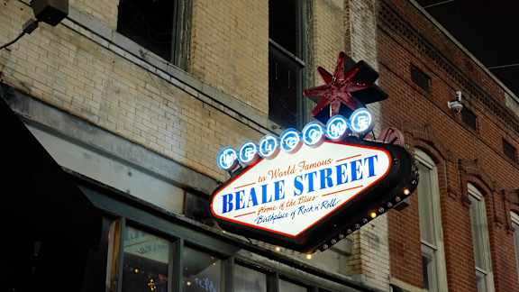 A neon sign for Beale Street is lit up at night.