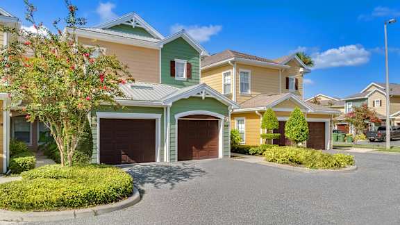 a house with a driveway and two garages in front of it