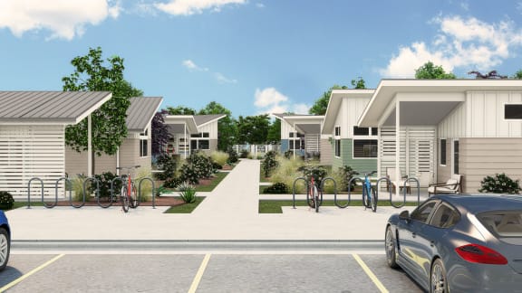 a row of houses with cars parked in a parking lot