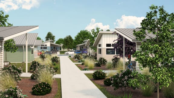 a neighborhood of manufactured homes with a sidewalk and landscaping