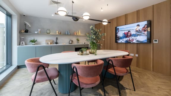 a dining room with a table and chairs and a tv