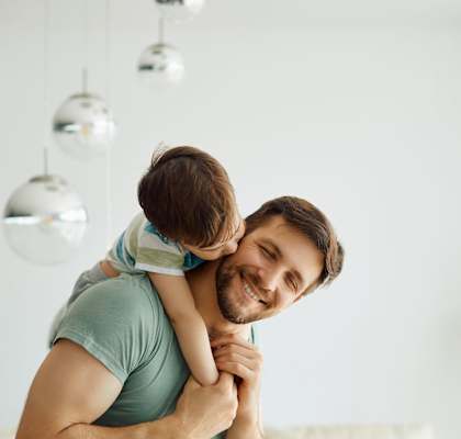 A man is holding a child in his arms at Nola 624 Apartments, West Covina, 91790