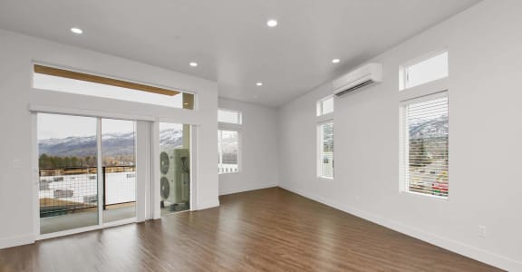 a living room with a hardwood floor and white walls