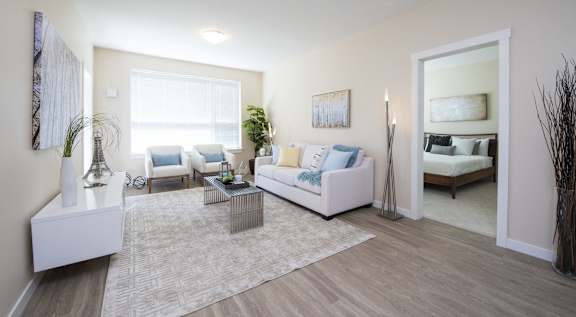 A living room with a white couch and a coffee table.