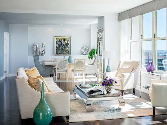 A living room with white furniture and a view of the city at Residences Providence, Providence, Rhode Island