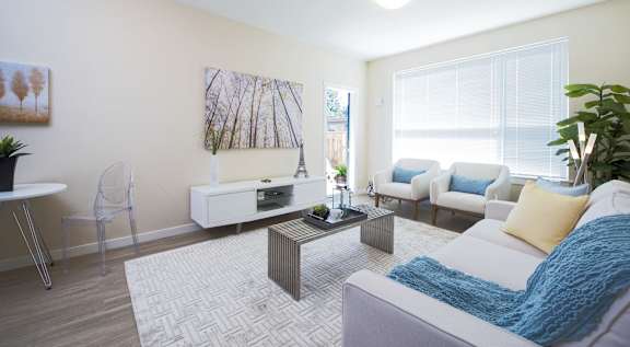 A living room with a white couch and a coffee table.