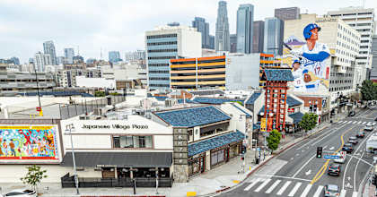 A street view of a city with a building that has a sign that says "Japanese Village Plaza".