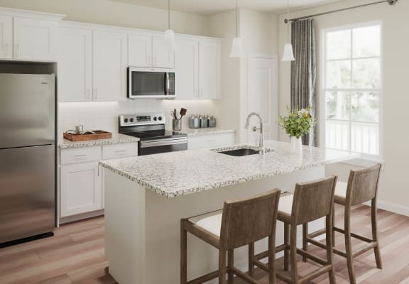 a white kitchen with a marble counter top at The Retreat at Brandywine Crossing, Brandywine, MD