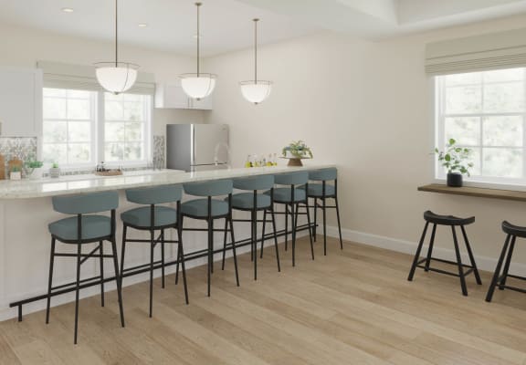 a kitchen with a large island and bar stools in front of a white counter at The Retreat at Brandywine Crossing, Brandywine, 20613