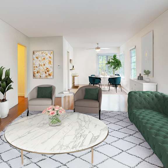 A living room with a green sofa and a white coffee table.