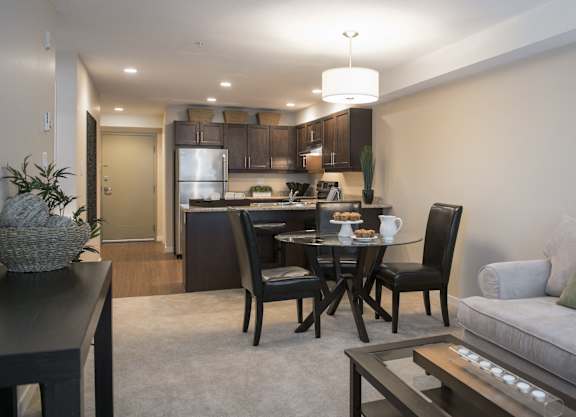 a living room and kitchen with a table and a couch